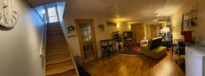 a room with a staircase and a living room at Country Roads Dwelling in Dundas