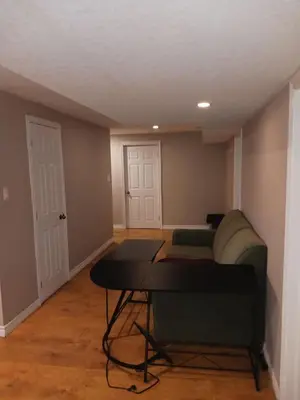 a living room with a couch and a table at Budget Stay In Heart of Waterloo-Free Wifi-Parking in Waterloo