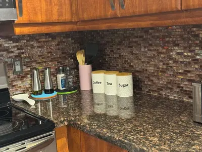 a kitchen counter with three coffee cups on it at Vibrant and Comfy Mississauga Home 20 mins from YYZ in Mississauga