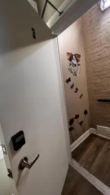 a hallway with a white wall with sunglasses on it at Downtown Private Room Central Location in Toronto