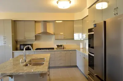 a kitchen with a sink and a refrigerator at Luxury 5 Bed Retreat for 12 with Gourmet Kitchen in Paris