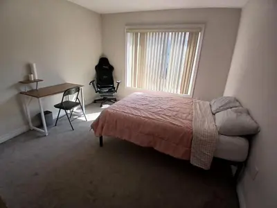 a bedroom with a bed and a desk and a window at Home away from home in Cambridge