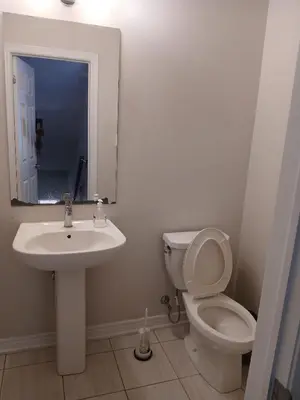 a bathroom with a sink and a toilet and a mirror at Home away from home in Cambridge