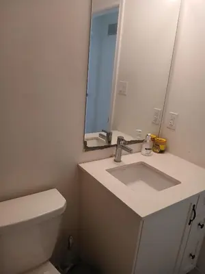 a bathroom with a sink and a mirror and a toilet at Home away from home in Cambridge