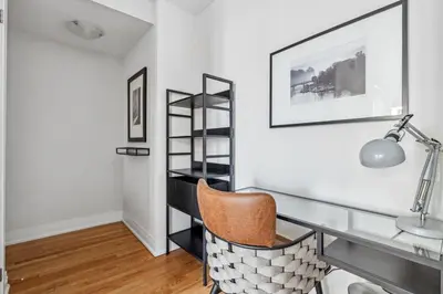 a desk in a room with a chair and a sink at Stunning 2BR Toronto Retreat, Patio & Parking in Toronto