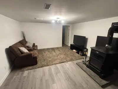 a living room with a couch and a television at Rice Lake Retreat in Roseneath
