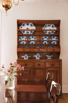 a table with blue and white plates on a wooden cabinet at The County Queen - Historic Home in Picton in Picton