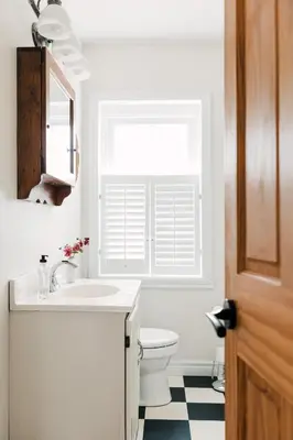 a bathroom with a sink and a toilet and a window at The County Queen - Historic Home in Picton in Picton