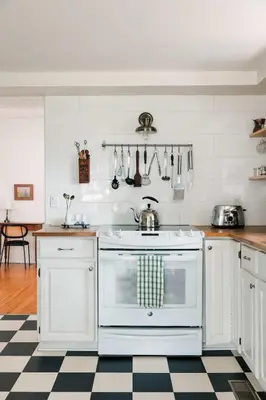 a kitchen with a white stove and a checkered floor at The County Queen - Historic Home in Picton in Picton