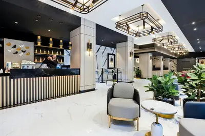 a lobby with a bar with a man standing at the counter at Riu Plaza Toronto in Toronto
