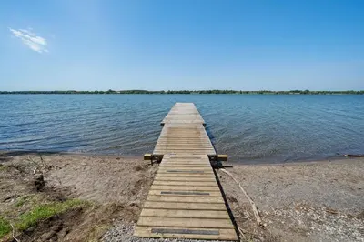 a wooden pier on the shore of a lake at The Sumac - 8 Natures in Cherry Valley