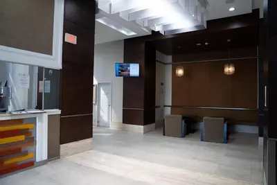 a lobby of an office building with a tv at Spacious 2 bedrooms 2 bathrooms with Cozy Charm plus 1 Parking in Mississauga