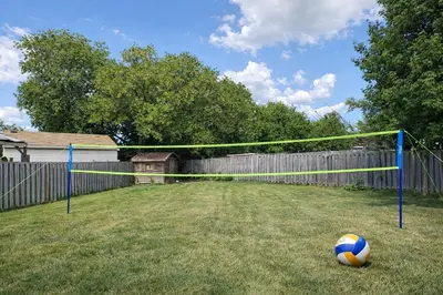 a soccer ball sitting in front of a net at Newly Renovated 3BR North York Bungalow with Backyard Patio & Volleyball Set! Close to Rogers Stadium, TTC Subway Access, Perfect for Family Travel, Group Trips & Work Stays! in Toronto