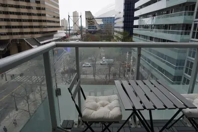 a balcony with a bench and a view of a city at Downtown Toronto Condo with CN Tower View in Toronto