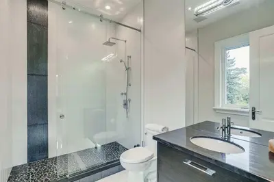 a bathroom with a shower and a toilet and a sink at Elegant Home with Yard and Comforts in Richmond Hill