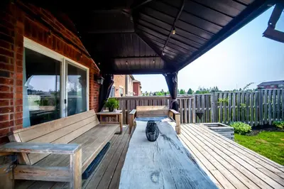 a porch with benches and awning on a house at Private Room In Luxury Home in Innisfil