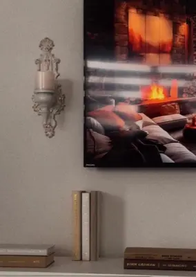 a picture hanging on a wall with a book shelf with a fireplace at Private Room In Luxury Home in Innisfil
