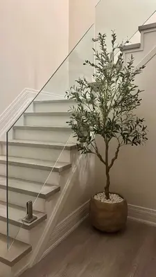 a tree in a pot next to some stairs at Private Room In Luxury Home in Innisfil