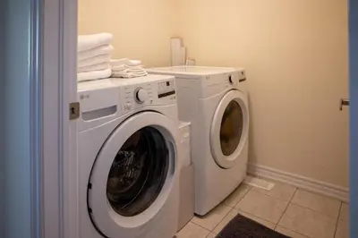a laundry room with a washer and dryer at Modern 3Bed Home 10 Mins to Niagra Falls in Thorold