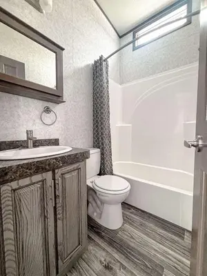 a bathroom with a toilet and a tub and a sink at Bobcaygeon Shores Cottage Resort in Kawartha Lakes