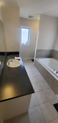 a bathroom with a sink and a bath tub at 15 mins from Niagara falls-5 Bedrooms Inn in Thorold