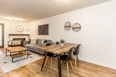 a living room with a table and a couch at The Landing Pad - Condo in Collingwood in Collingwood