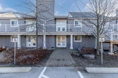a large house with a parking lot in front of it at The Landing Pad - Condo in Collingwood in Collingwood