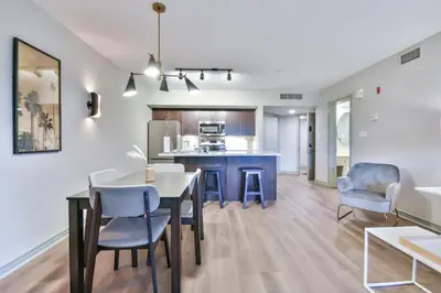 a kitchen and living room with a table and chairs at Highland Hideaway 1BR King Suite in Shanty Bay