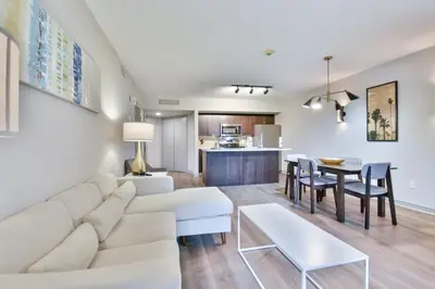 a living room with a white couch and a table at King Suite heated Pool Sauna and Kitchen in Shanty Bay