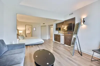 a living room with a bed and a couch and a kitchen at Hideaway 2BR Condo Pool & Heated Pool in Shanty Bay