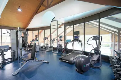 a gym with a bunch of treadms and cardio machines at Modern, fully renovated Studio! in Shanty Bay