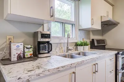 a kitchen with a sink and a microwave at Nest in the Orchard--cozy room in Toronto