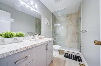 a bathroom with a sink and a toilet and a shower at Nest in the Orchard--cozy room in Toronto
