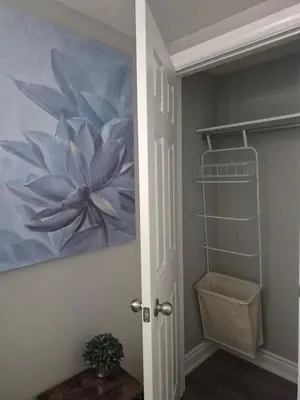 a painting of a flower on the wall in a bathroom at Two bedroom basement apartment in Whitby