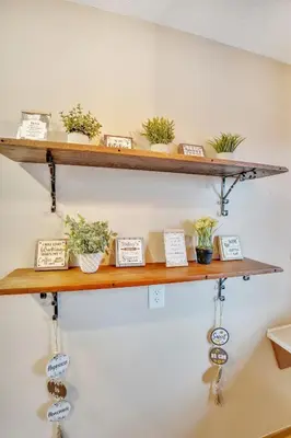 a shelf with potted plants and signs on it at Luxurious waterfront cottage in Bowmanville