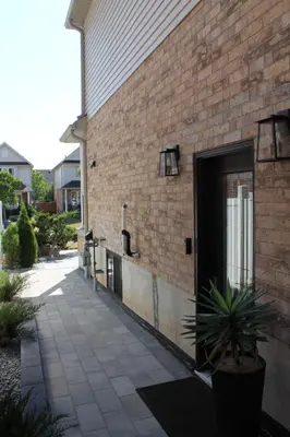 a brick building with a door on the side of it at Queen Bed Suite-Private Entrance in Barrie