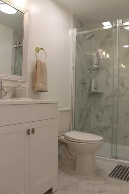 a bathroom with a toilet and a glass shower at Queen Bed Suite-Private Entrance in Barrie
