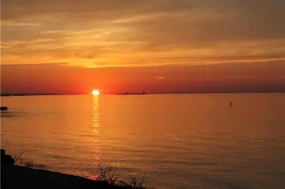 a sunset over a large body of water at Wavy Daze in Wasaga Beach