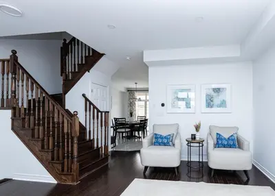 a living room with two chairs and a staircase at Vacation Home in Vaughan in Vaughan