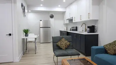 a kitchen and living room with a couch and a table at Beautiful Separate Unit, GrandRiver & Kiwanis Park in Kitchener