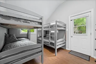 a bedroom with two bunk beds and a window at Lake lodge 6 in Frankford
