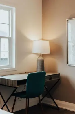 a desk with a chair and a lamp on it at Instaworthy Home - Relaxing Patio - Hot tub & BBQ in Cambridge
