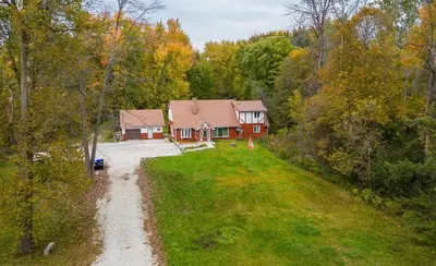 an aerial view of a house in the woods at Four and half bedrooms 10 Acres of forest with trails in Tottenham