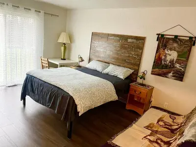a bedroom with a bed with a wooden headboard at Four and half bedrooms 10 Acres of forest with trails in Tottenham
