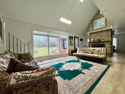 a living room with a couch and a fireplace at Four and half bedrooms 10 Acres of forest with trails in Tottenham