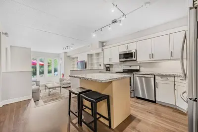 a kitchen with white cabinets and a counter top at Blue Mountain Haus - Private Patio - Walk to Blue in Blue Mountains