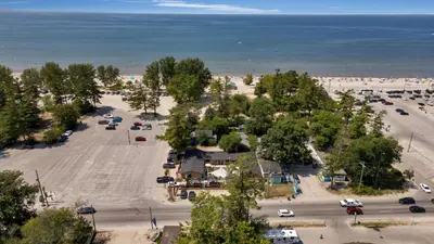 an aerial view of a parking lot next to the beach at Adrian's Suites 2 Bedroom Family Suite in Wasaga Beach