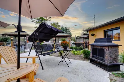 an umbrella sitting on a patio with a fireplace at Adrian's Suites 2 Bedroom Family Suite in Wasaga Beach