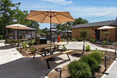 a picnic table with an umbrella at a restaurant at Adrian's Suites 2Bedroom Family Suite in Wasaga Beach