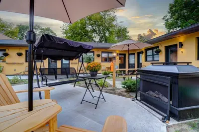 a patio with a grill and an umbrella at Adrian's Suites 2 Bedroom Family Suite in Wasaga Beach